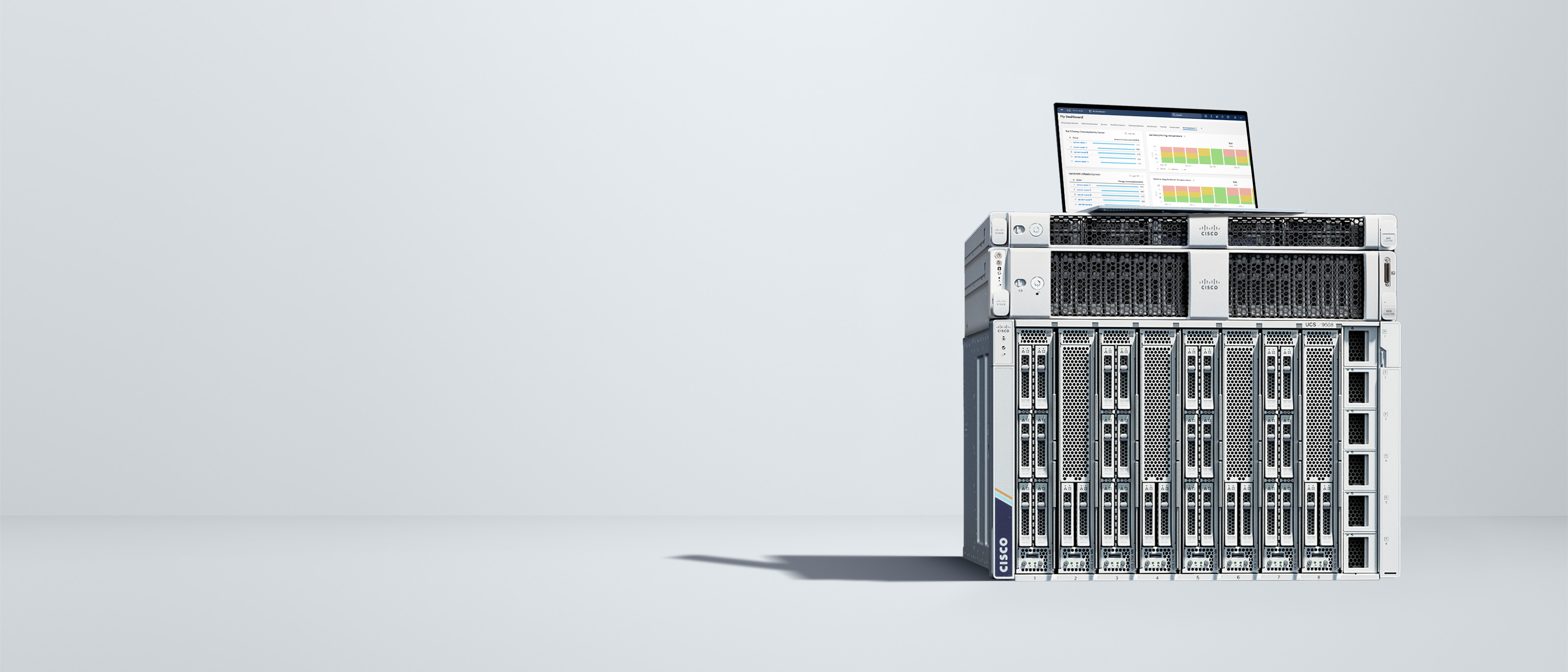 A UCS-X series modular server stacked with a UCS-C220 and a C240 rack server. An open laptop computer is on top of the stack displaying an Intersight dashboard