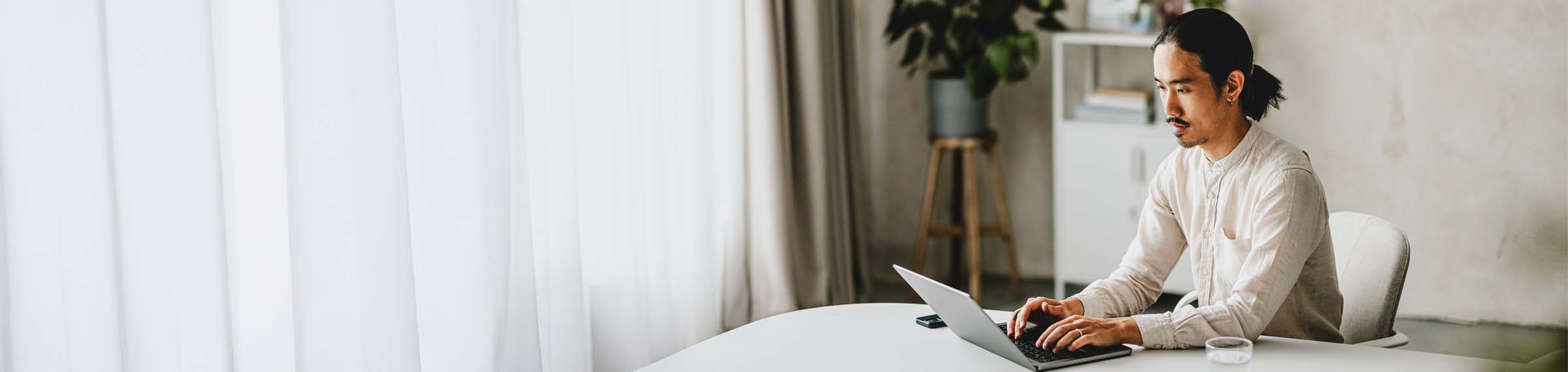 Man working on laptop in modern office