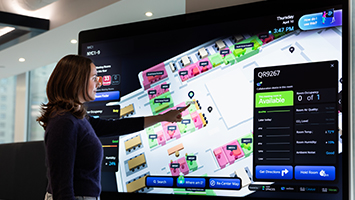 Woman using Cisco Spaces and interacting with wayfinding capabilities